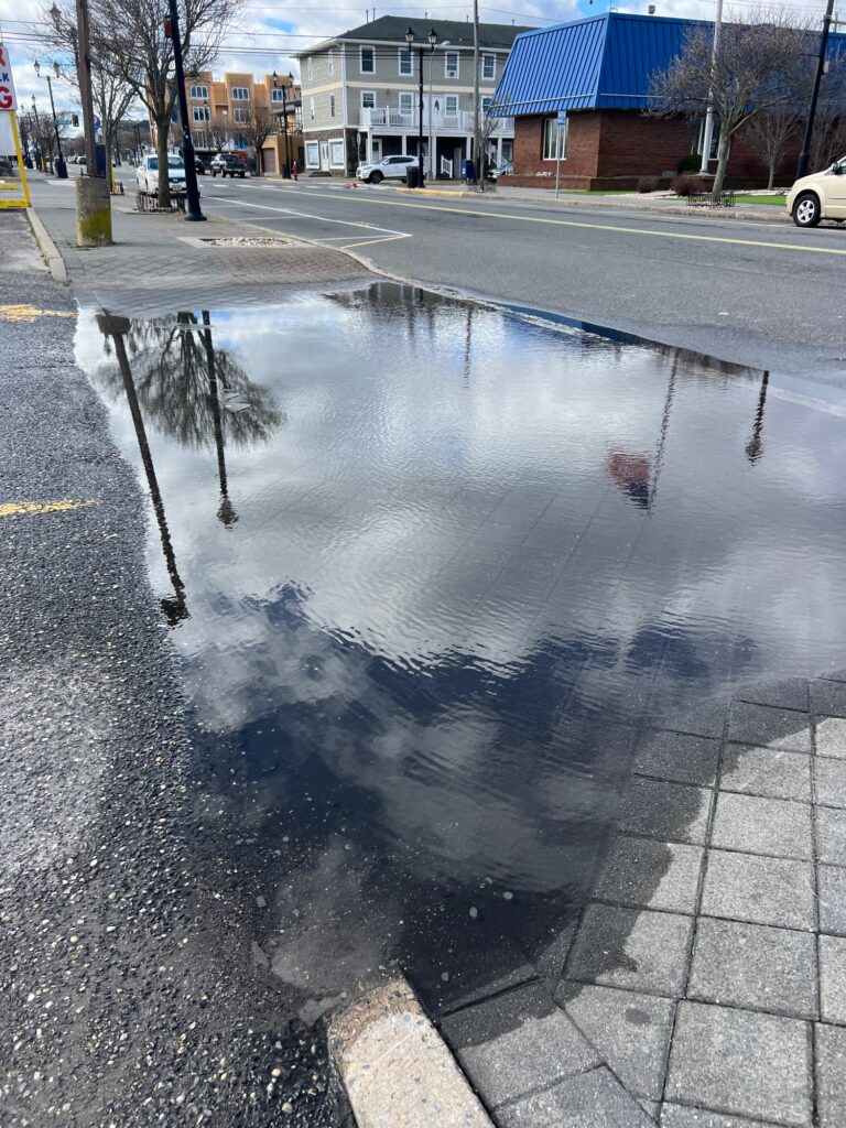 a puddle on the street (MyCoast AI)