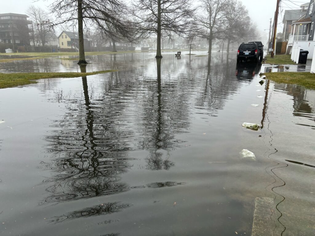 a flooded street with a car parked on the side (MyCoast AI)