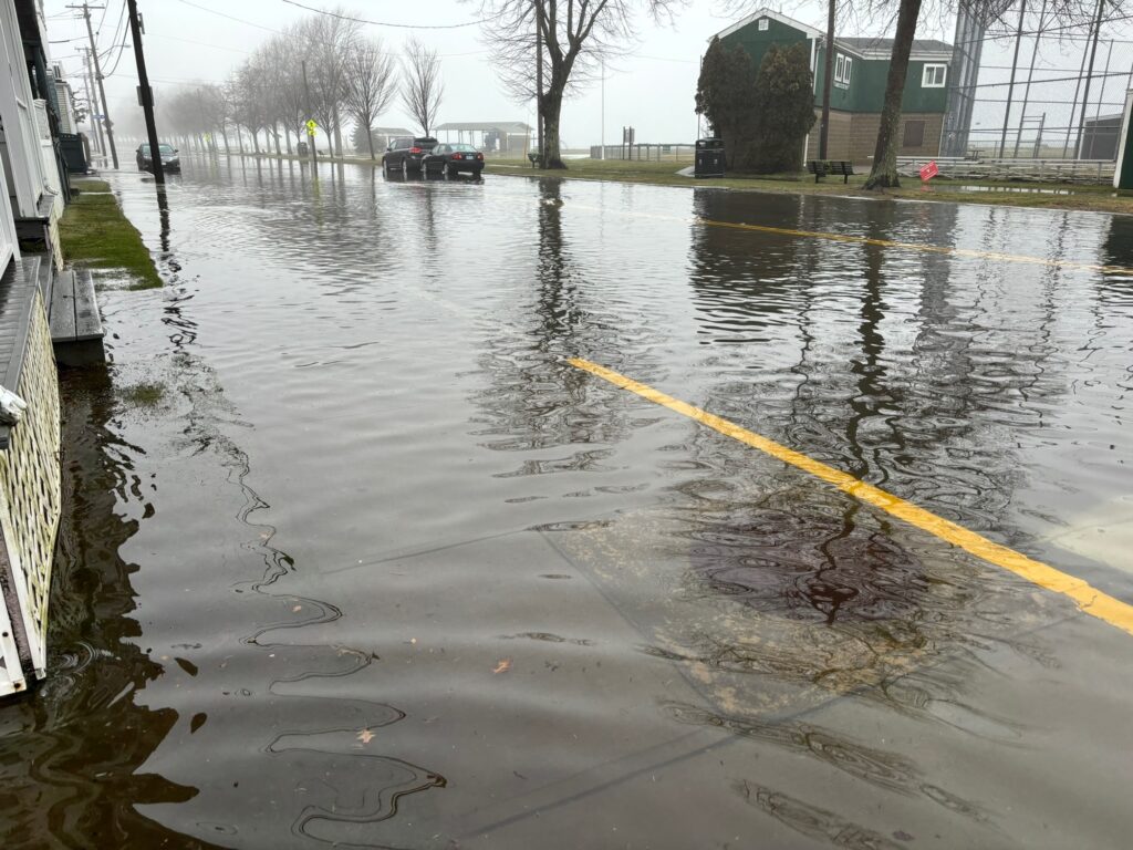 a flooded street with a boat (MyCoast AI)