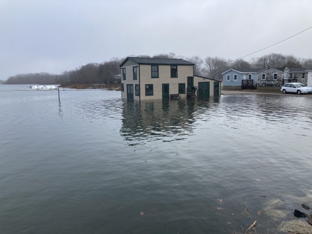 a flooded area with houses and a car parked in the water (MyCoast AI)