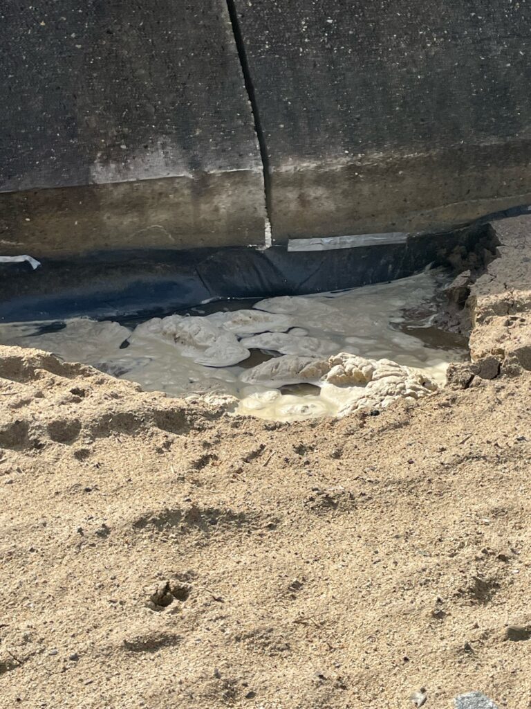 a dirty area with a hole in it (MyCoast AI)
