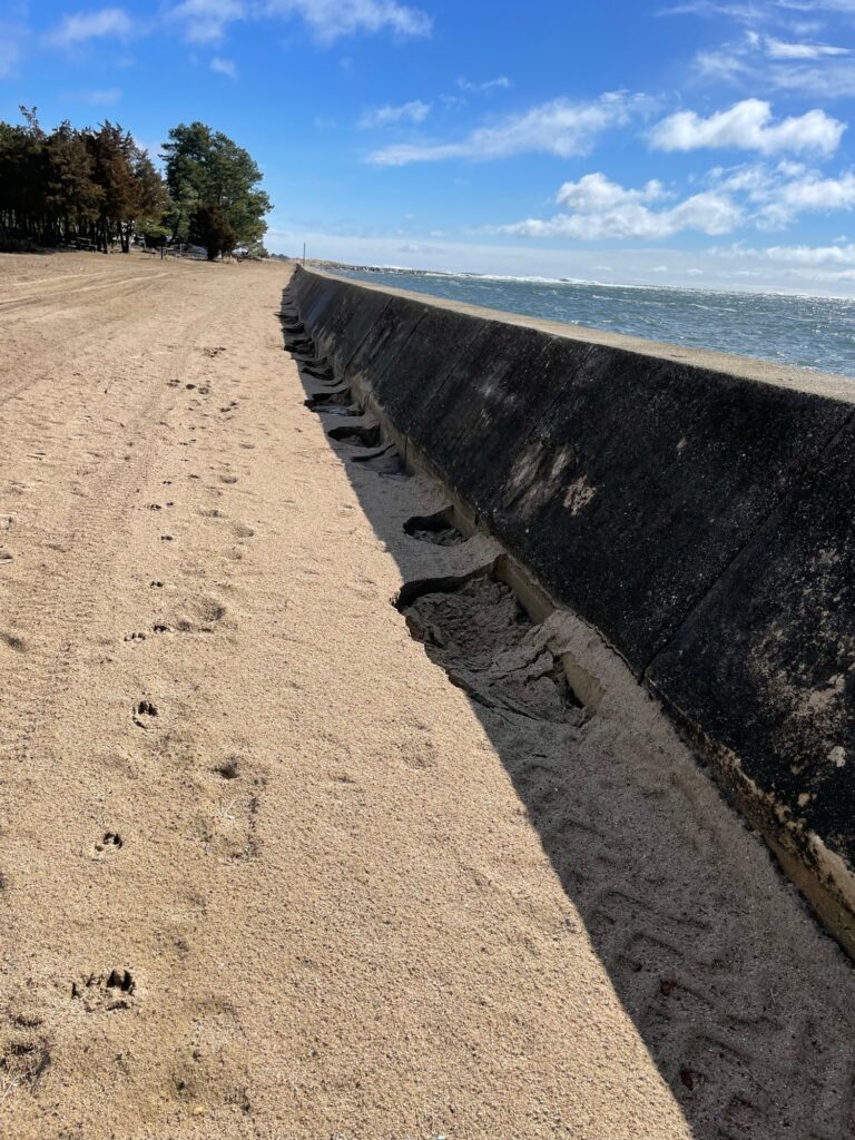 a concrete wall next to a beach (MyCoast AI)