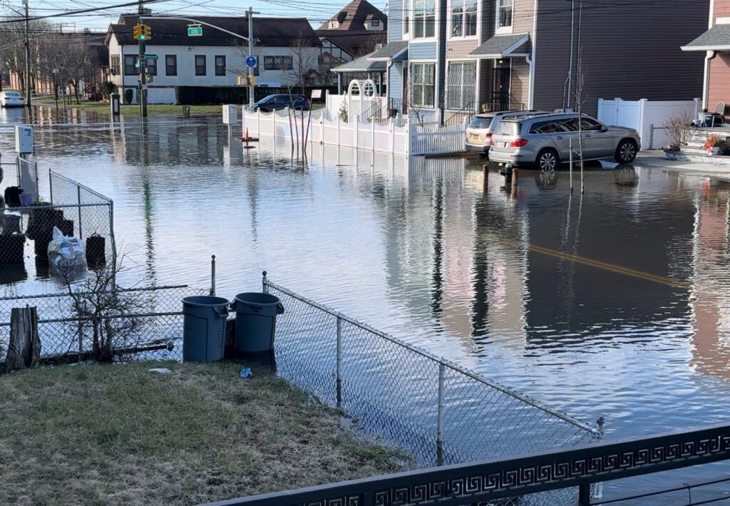a flooded street with cars parked on the side (MyCoast AI)