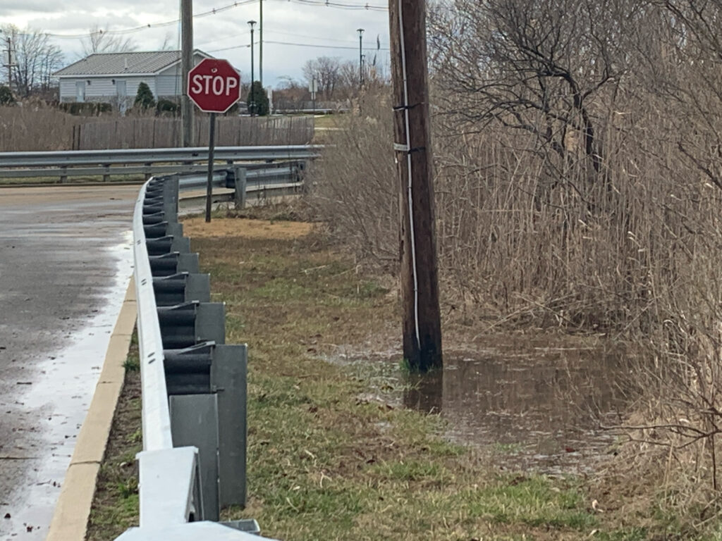 a stop sign on the side of a road (MyCoast AI)