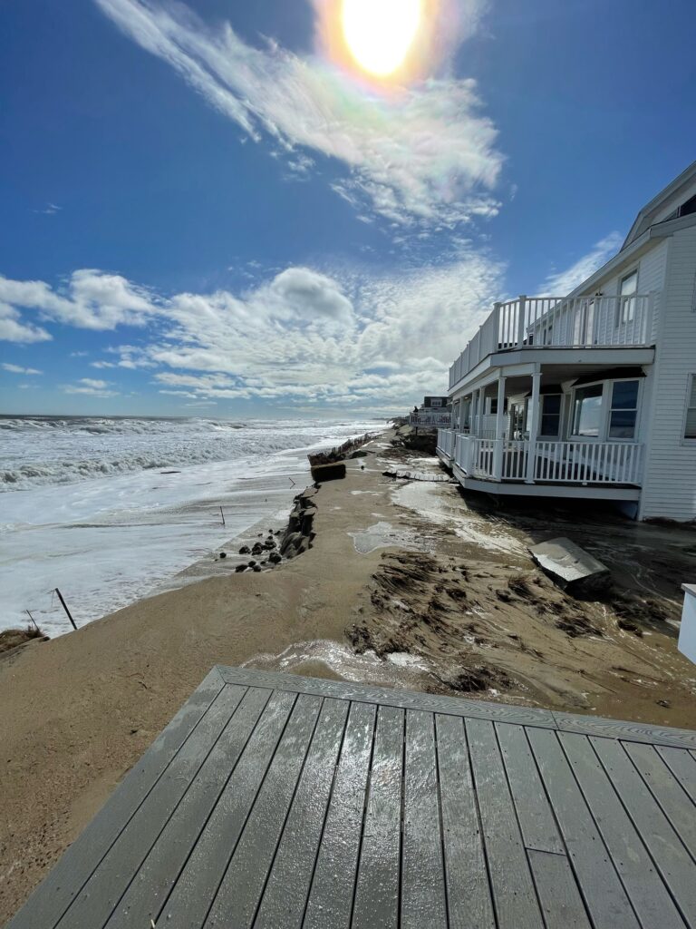 a beach with a building and a body of water (MyCoast AI)