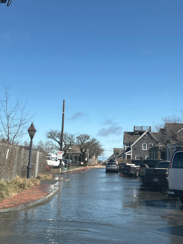 a flooded street with cars parked on the side (MyCoast AI)