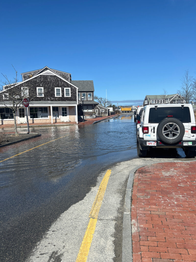 a truck driving through a flooded street (MyCoast AI)