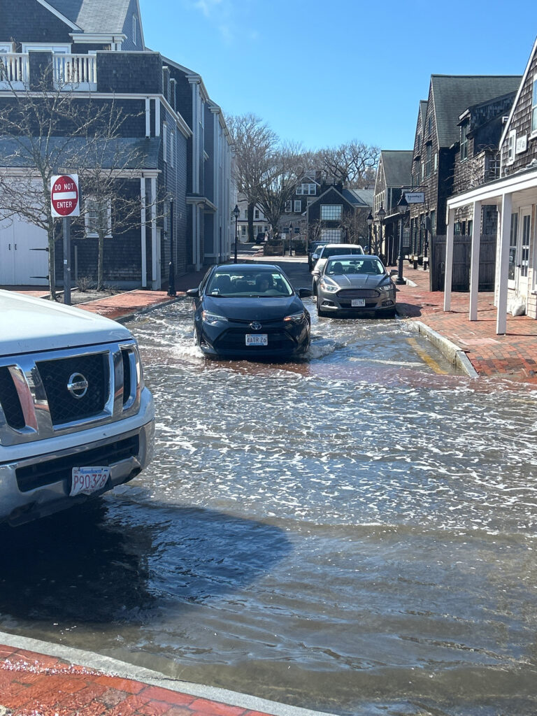 a flooded street with cars parked on the side (MyCoast AI)