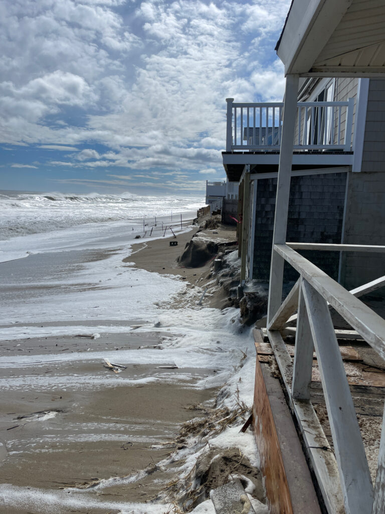 a beach with a pier and a building (MyCoast AI)