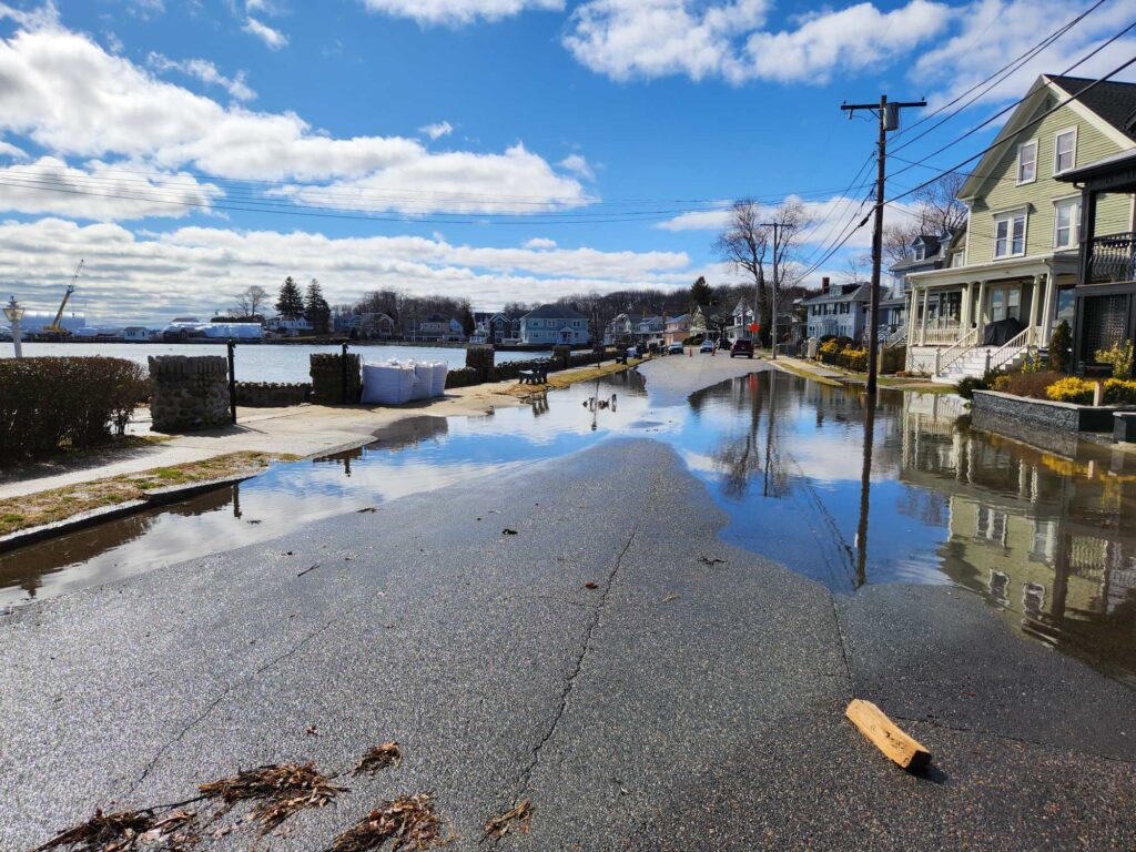 a flooded street with houses and trees (MyCoast AI)