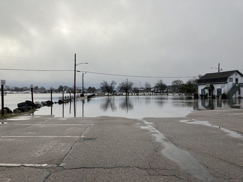 a flooded street with a house and trees (MyCoast AI)