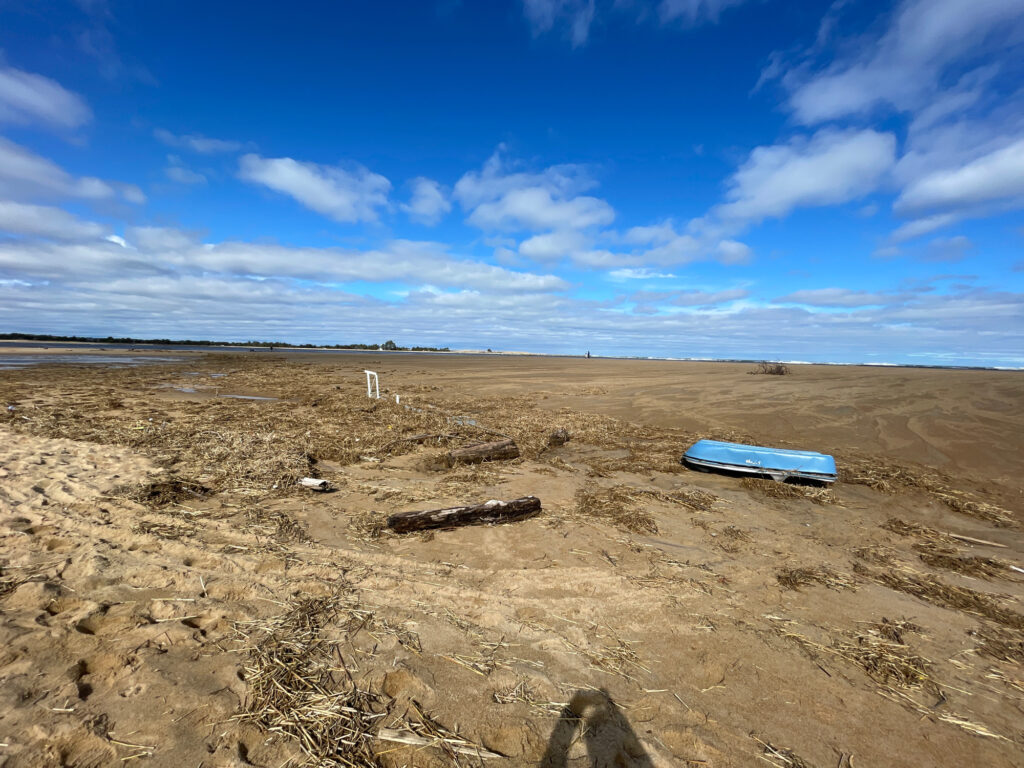 a blue boat on a sandy beach (MyCoast AI)