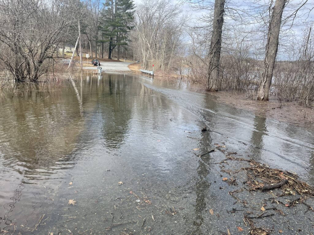 a flooded road with trees on either side of it (MyCoast AI)