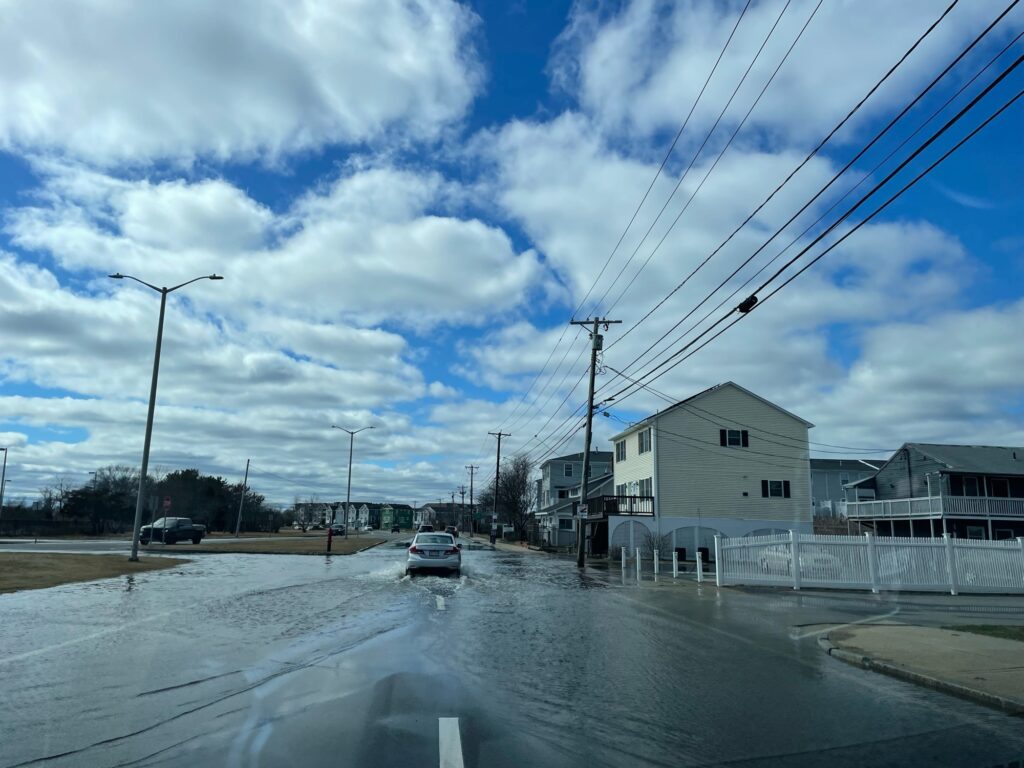 a road with cars on it and houses along it (MyCoast AI)