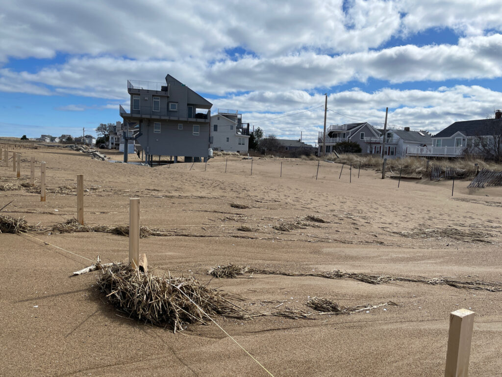 a dirt field with a house in the background (MyCoast AI)