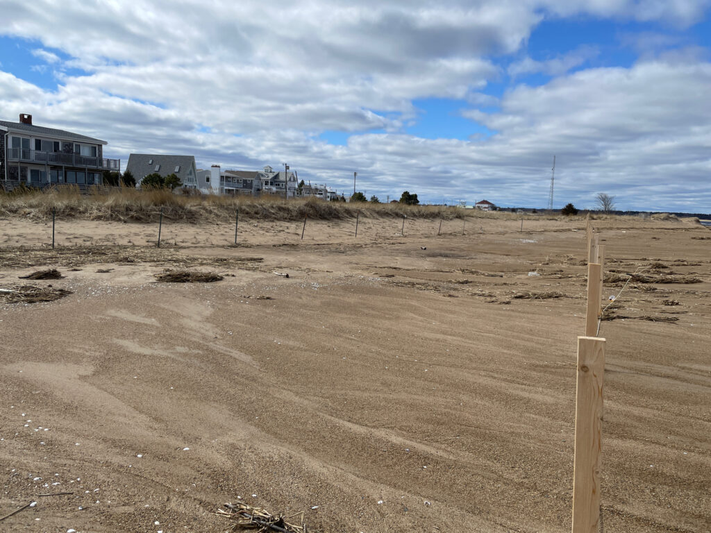 a dirt field with buildings in the background (MyCoast AI)