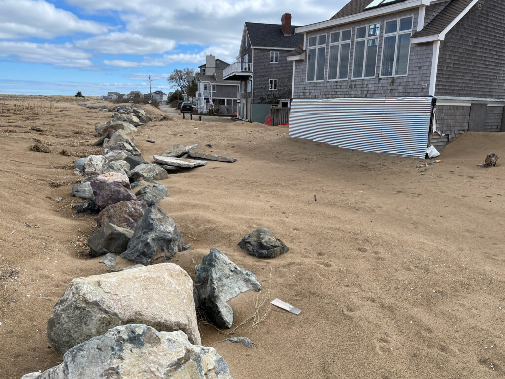 a pile of rocks in front of a building (MyCoast AI)
