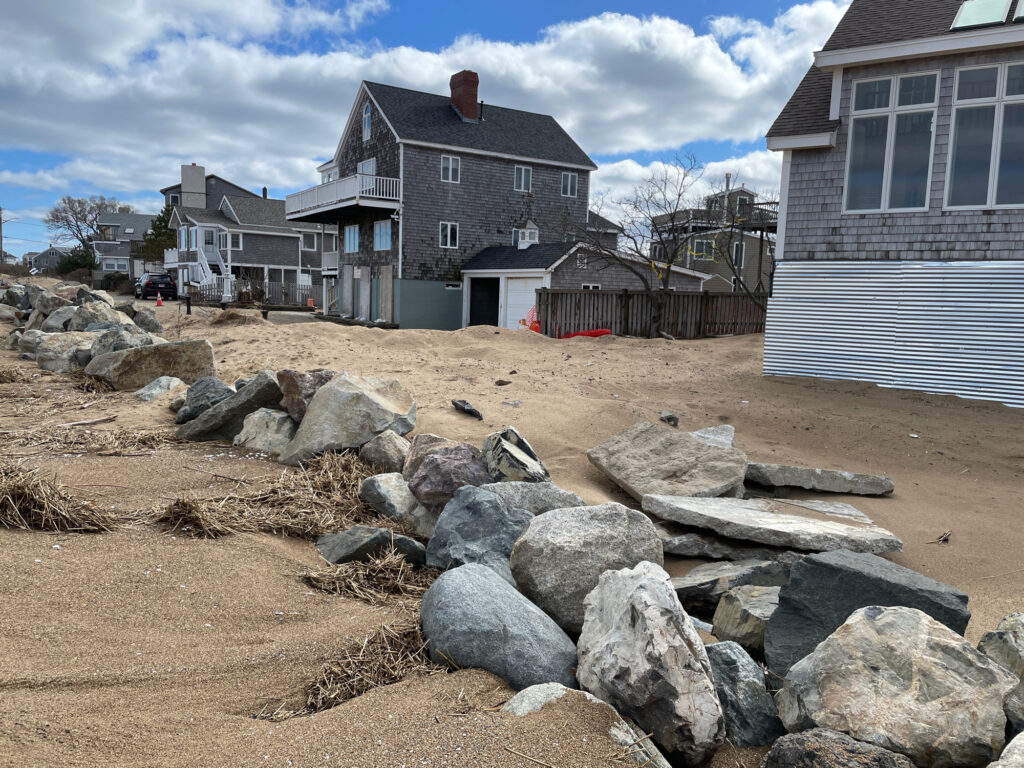 a pile of rocks in front of a house (MyCoast AI)