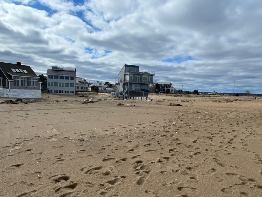 a sandy beach with buildings in the background (MyCoast AI)