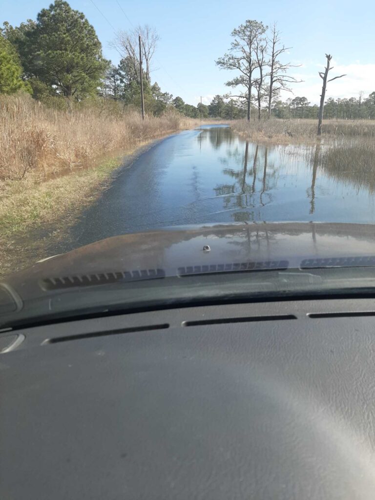 a car driving on a flooded road (MyCoast AI)