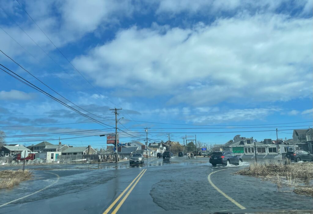 a road with cars on it and buildings on the side (MyCoast AI)