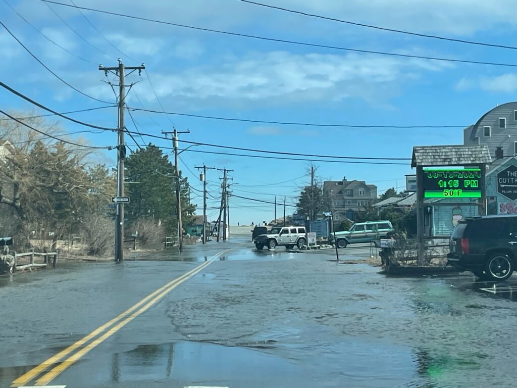 a wet road with cars and power lines on the side (MyCoast AI)