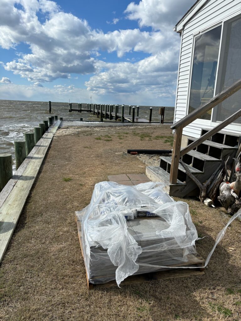 a white tarp on a wooden deck next to a building (MyCoast AI)