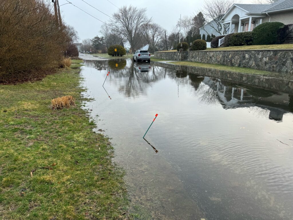 a flooded street with a car parked on the side (MyCoast AI)