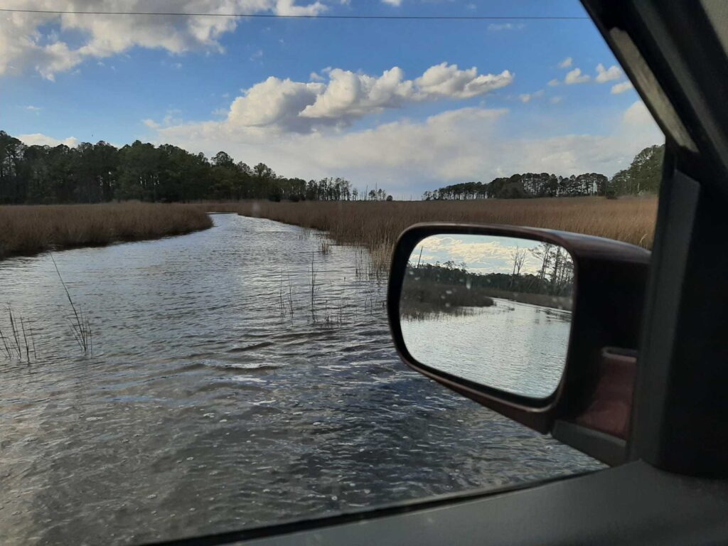 a car mirror showing a river (MyCoast AI)