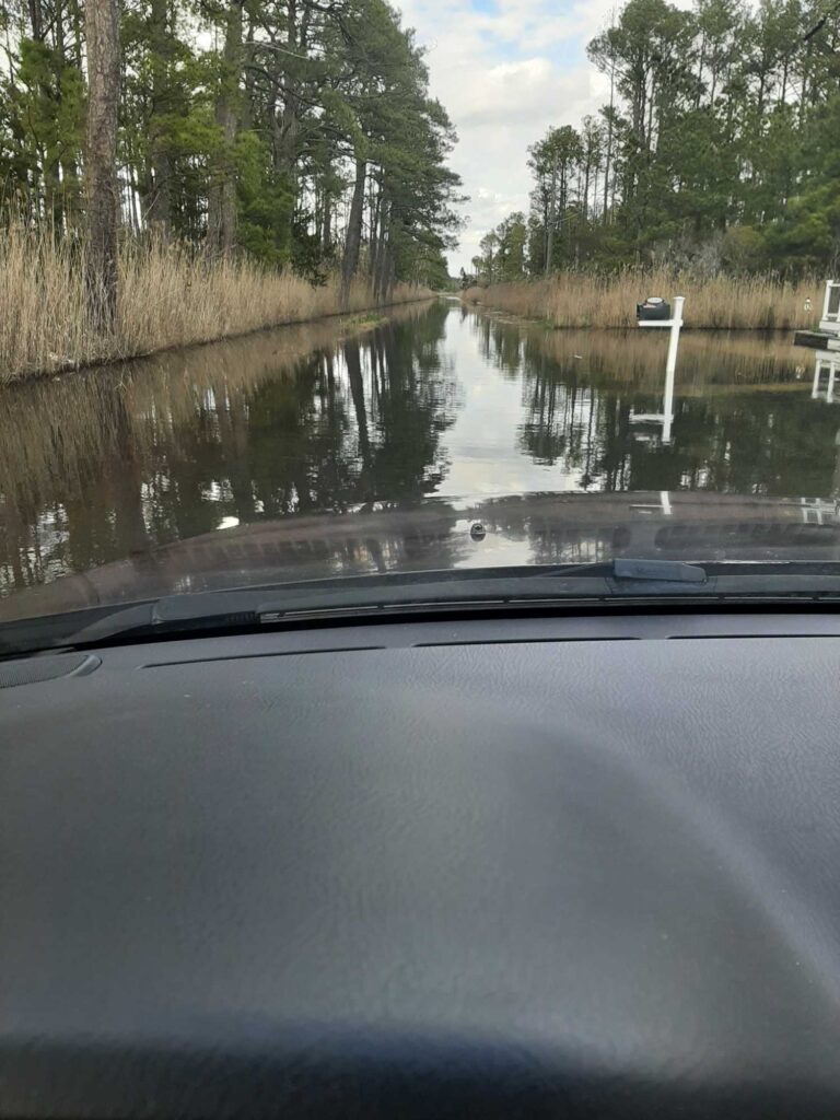 a car driving on a flooded road (MyCoast AI)
