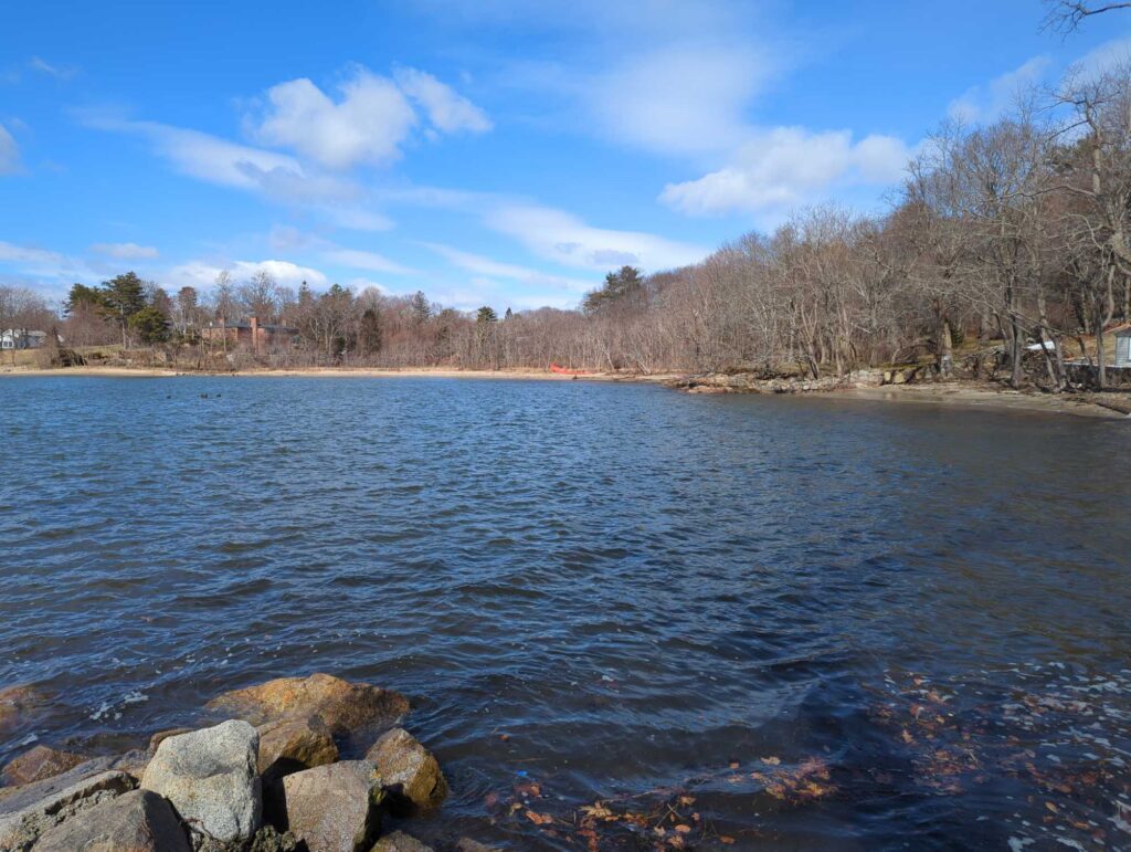 a body of water with rocks and trees around it (MyCoast AI)