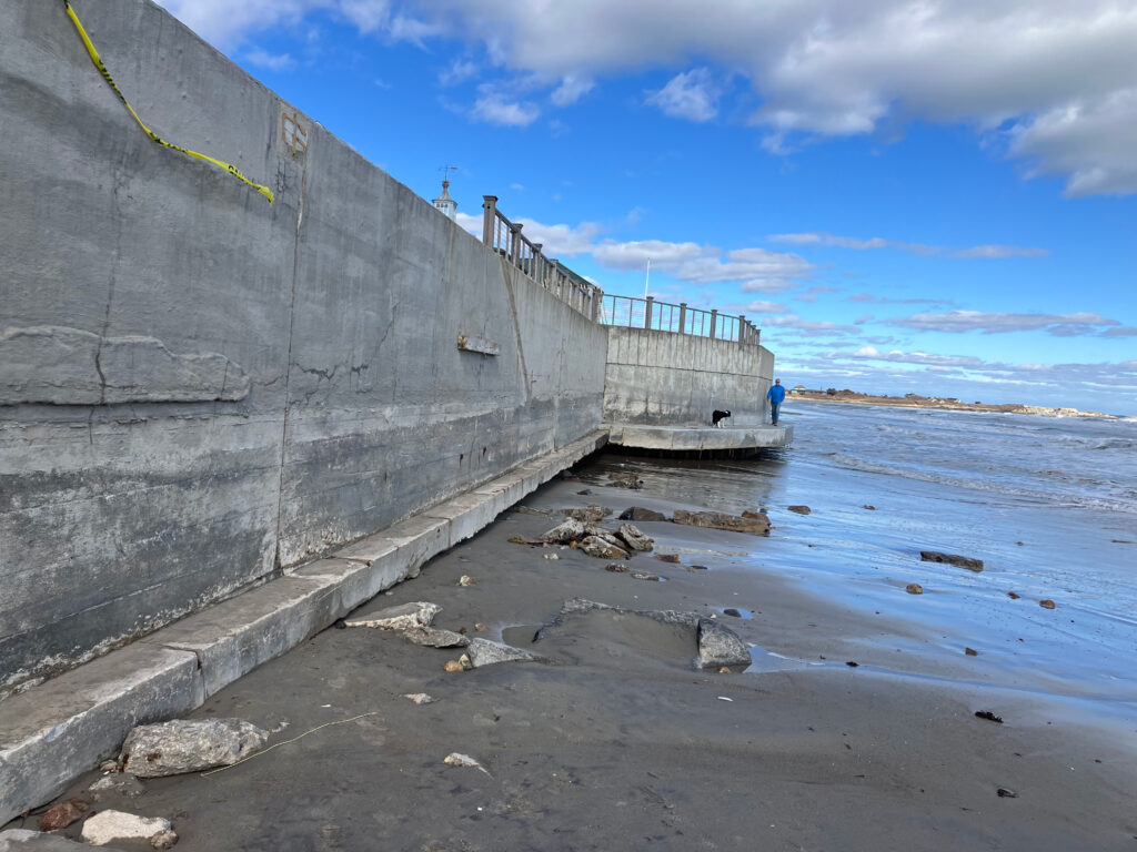 a concrete wall next to a beach (MyCoast AI)