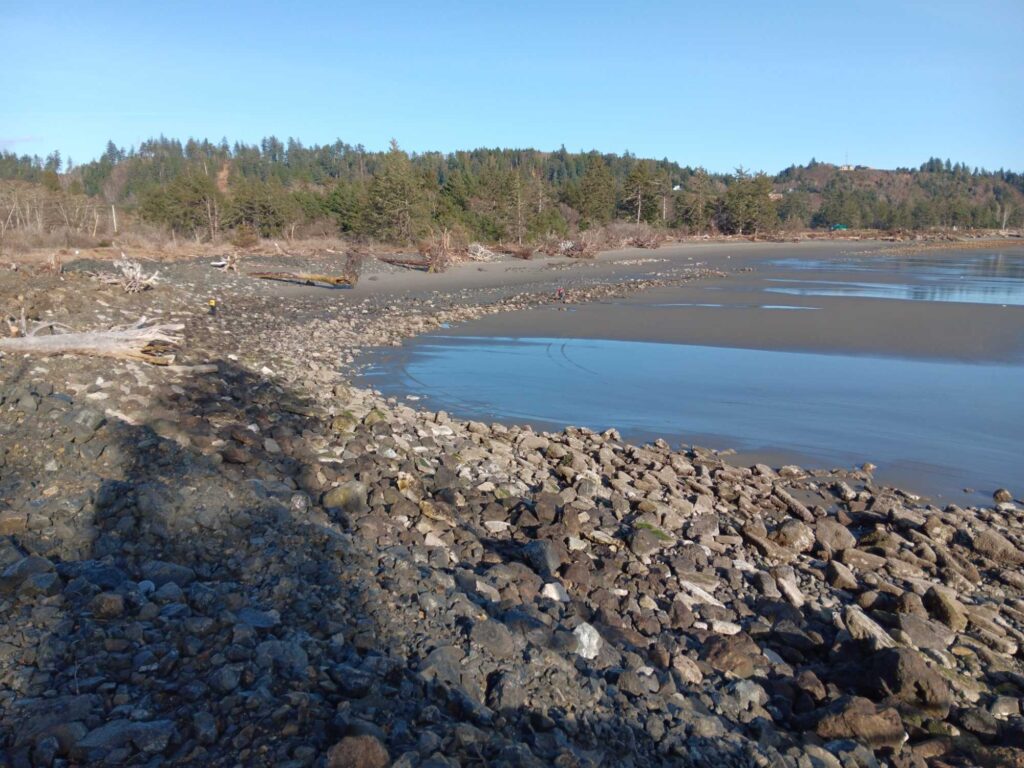 a rocky beach with a body of water in the background (MyCoast AI)