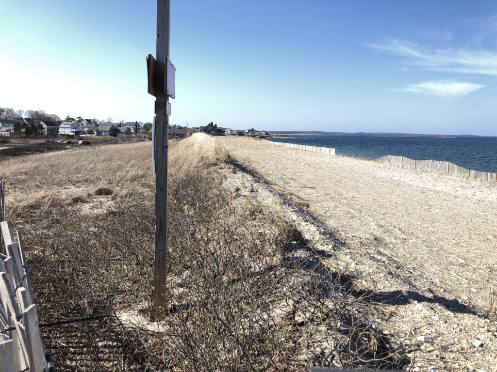 a sandy beach with a sign (MyCoast AI)