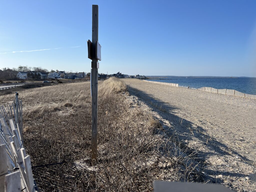 a sandy beach with a fence (MyCoast AI)