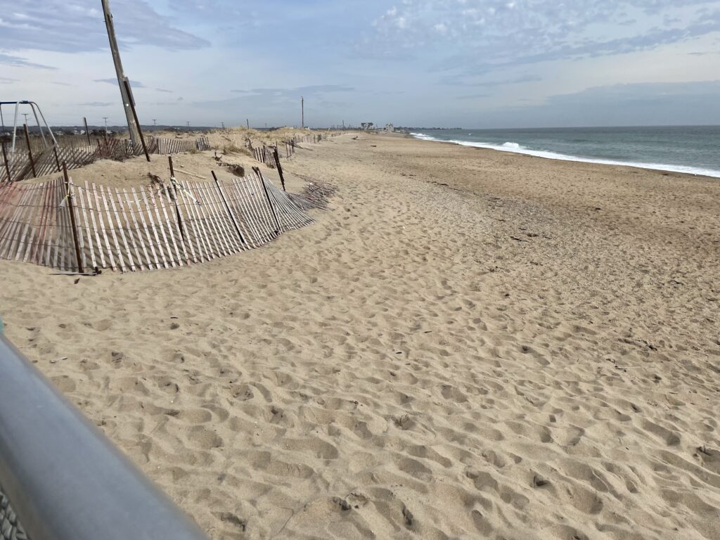 a sandy beach with a fence (MyCoast AI)