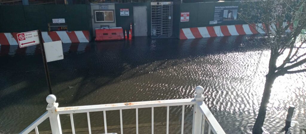 a flooded area with a white fence (MyCoast AI)