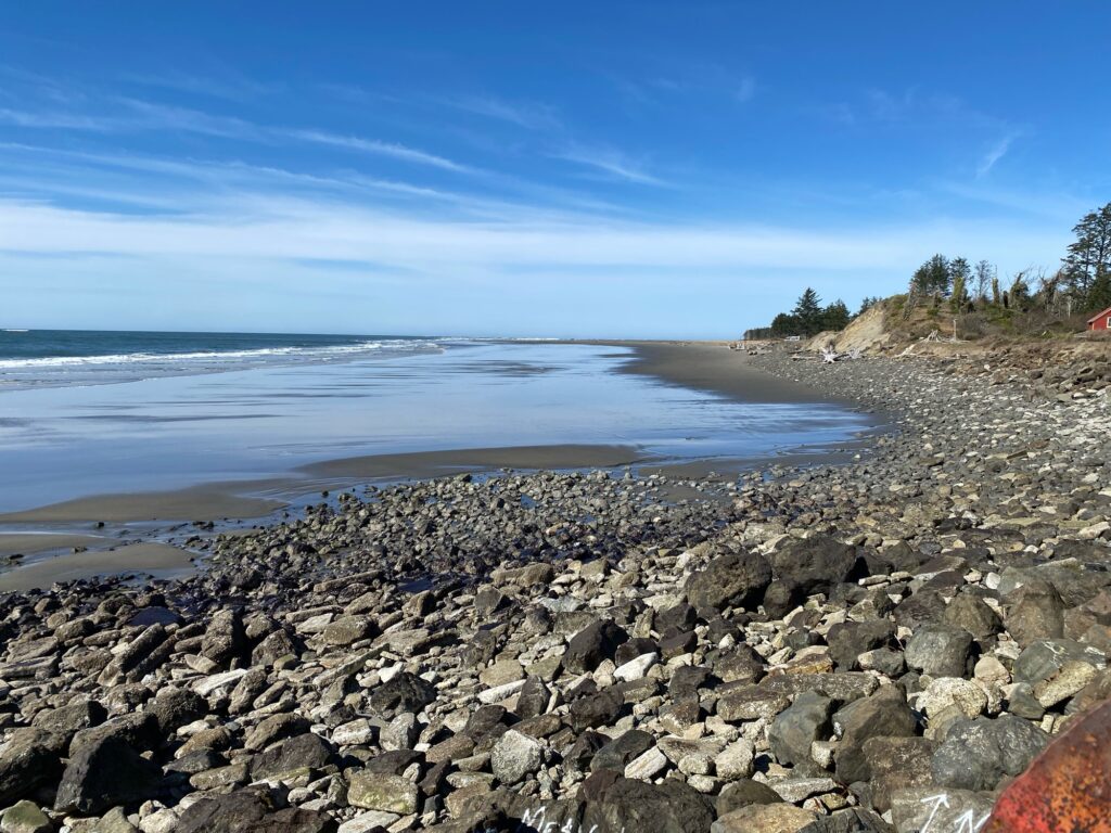 a rocky beach with a body of water in the background (MyCoast AI)