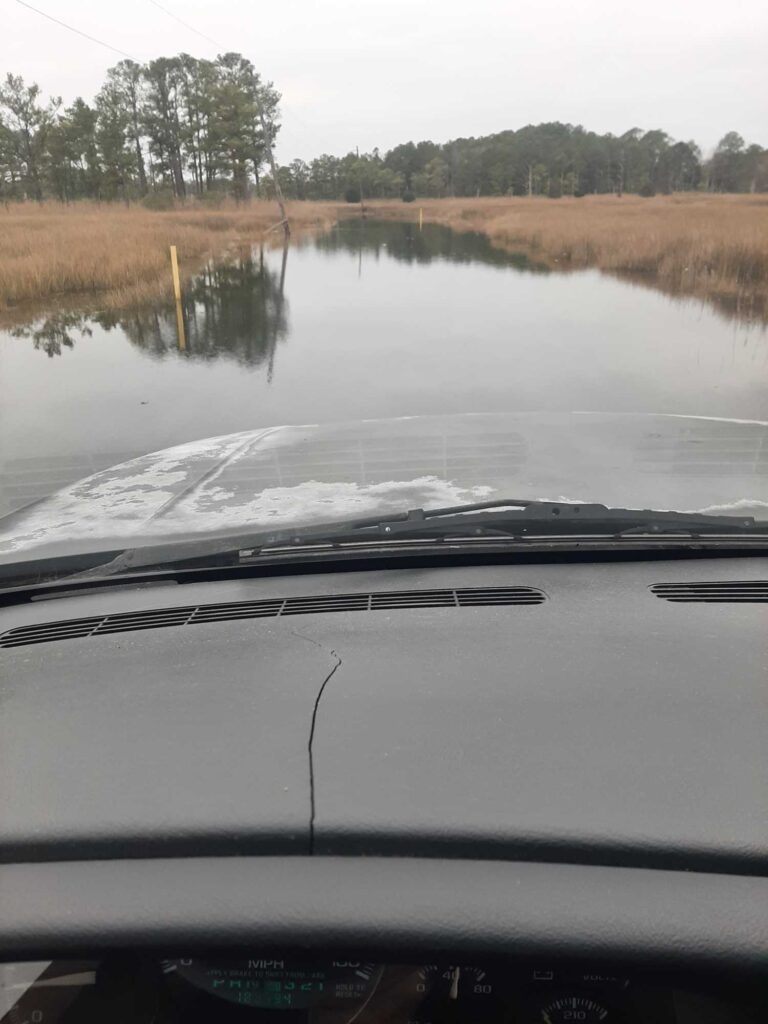 a car driving on a flooded road (MyCoast AI)