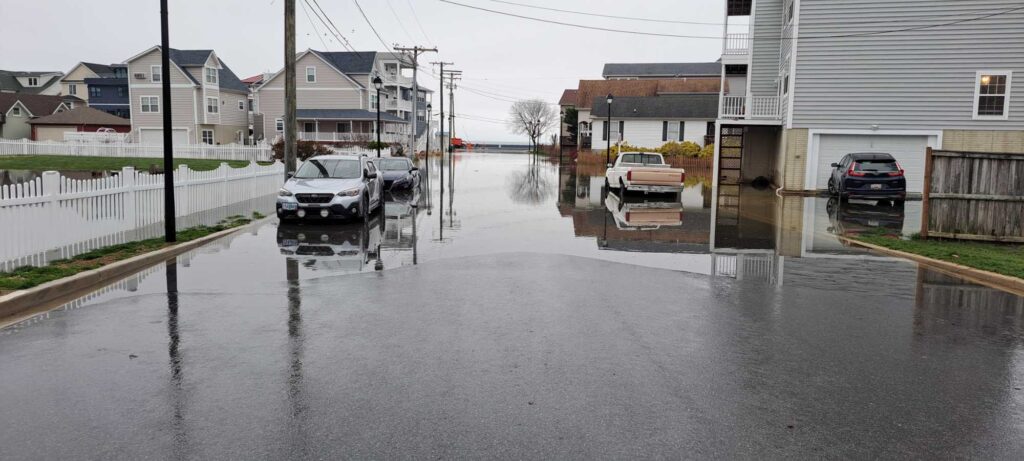 a flooded street with cars and houses (MyCoast AI)
