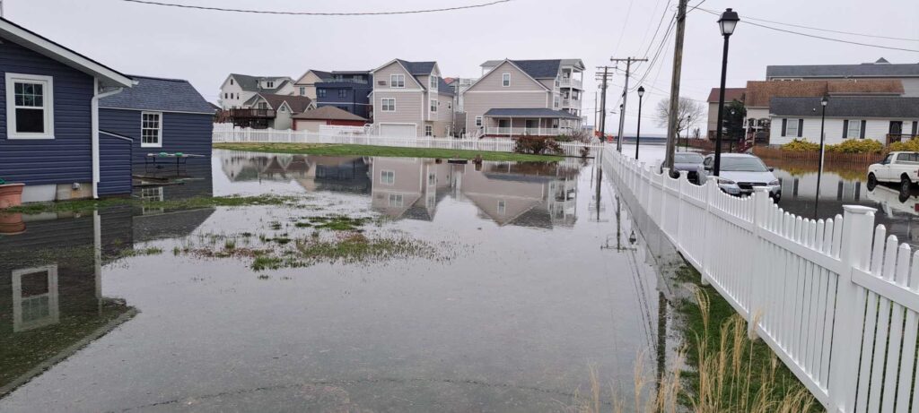 a flooded street with houses on either side of it (MyCoast AI)