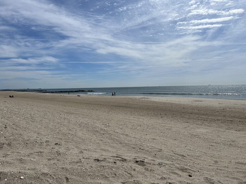 a sandy beach with people walking on it (MyCoast AI)
