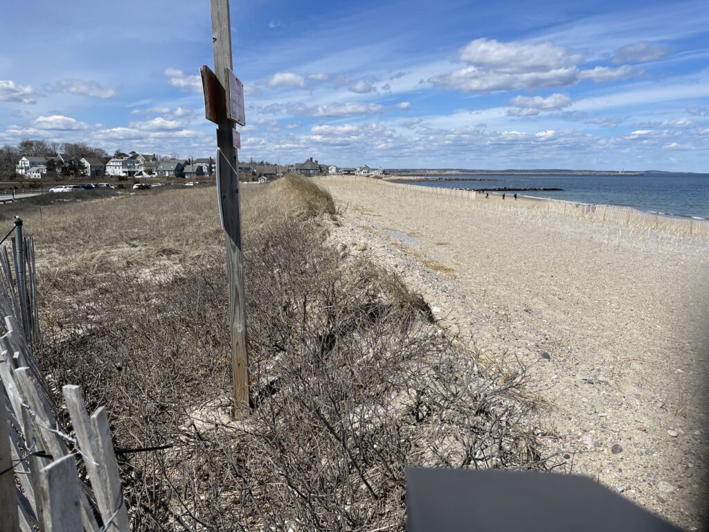 a beach with a fence and a pole (MyCoast AI)