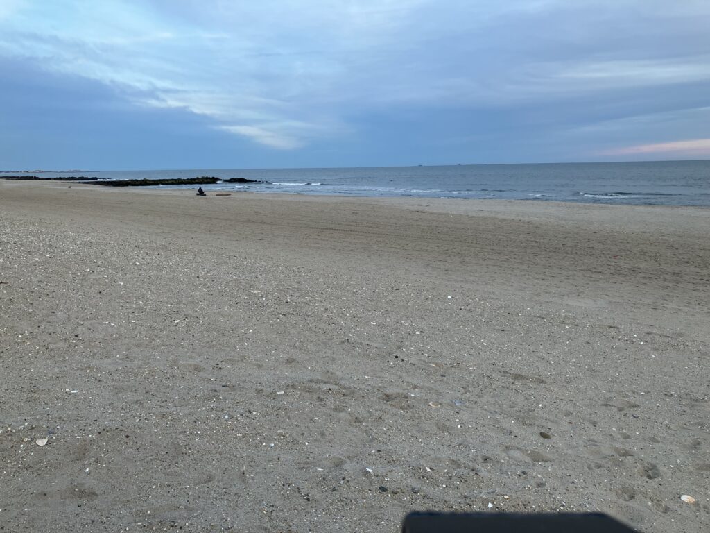 a sandy beach with water and blue sky (MyCoast AI)