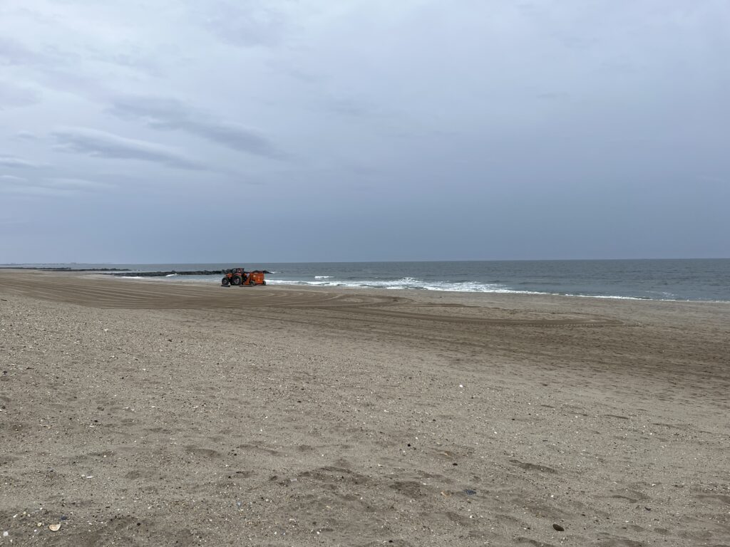 a beach with a couple of people on it (MyCoast AI)