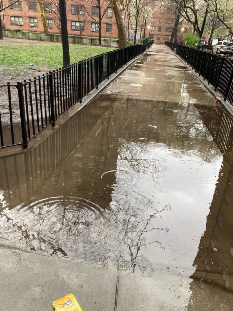 a puddle of water on a sidewalk (MyCoast AI)