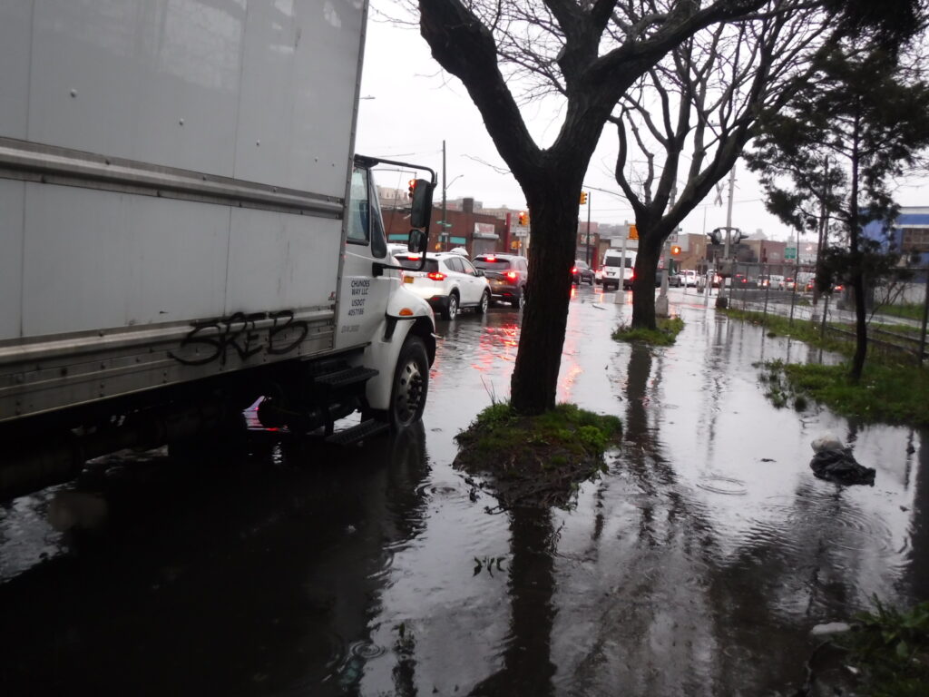 a truck driving through a flooded street (MyCoast AI)
