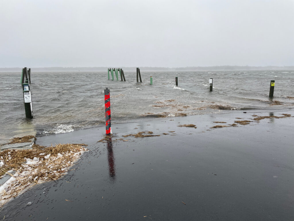 a beach with poles and signs (MyCoast AI)