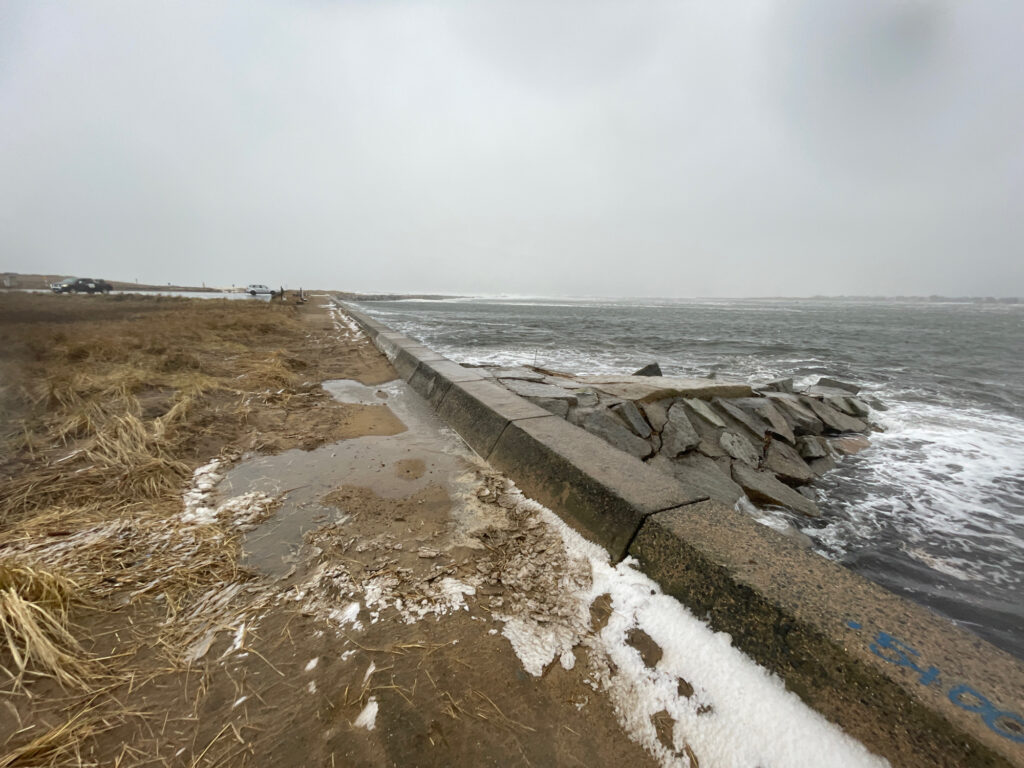 a stone wall next to a body of water (MyCoast AI)