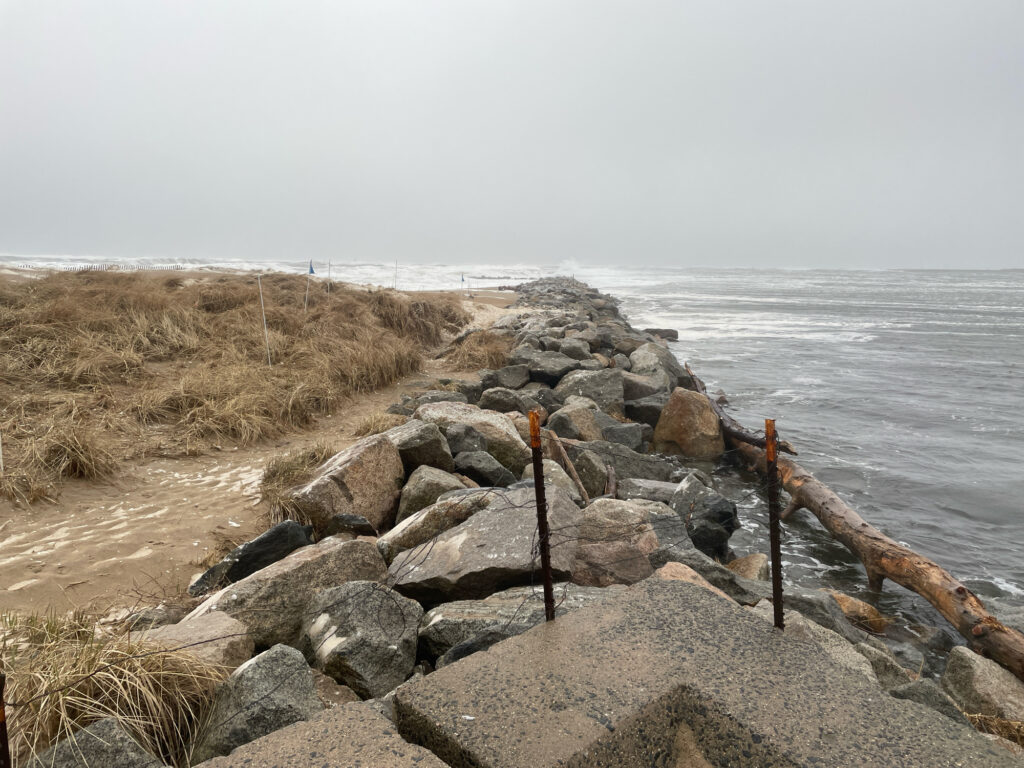 a rocky beach with a fence (MyCoast AI)